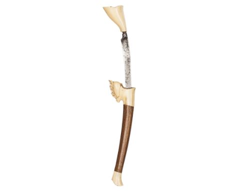 A small Malayan knife bade bade, slender curved blade 5¼”, in its brown wood sheath with ivory locket and tip of transitional