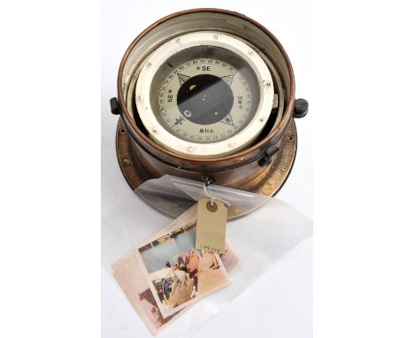 A ship’s compass,  gimbal ring mounts, in lower half of its flanged brass case, with plate “Patt. 0183. No 192868”, overall d