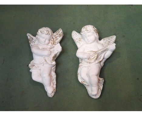 A pair of ceramic wall hanging cherubs