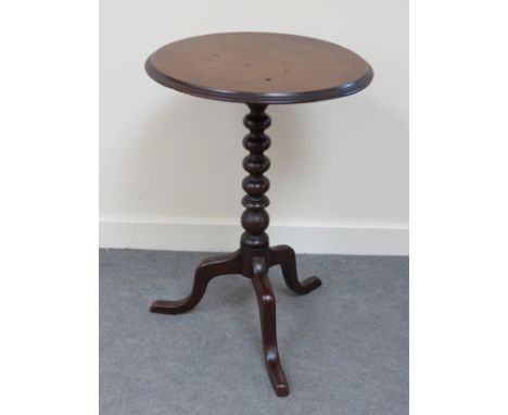 A 19th Century mahogany tilt top wine table the circular top over a bobbin turned column on a tripod base