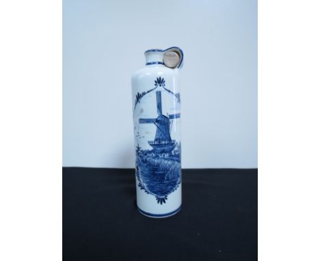 A Delft blue and white bottle containing Bols Geneva Gin