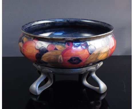 A William Moorcroft pomegranate design bowl on William Hutton & Sons pewter stand of Arts & Crafts form, chip to rim.  Circa 