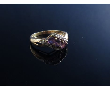 A 9ct gold amethyst and diamond ring, open shoulders 