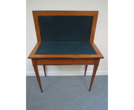 A 19th Century card table with ebonised decoration the hinged swivel top over square tapering legs 