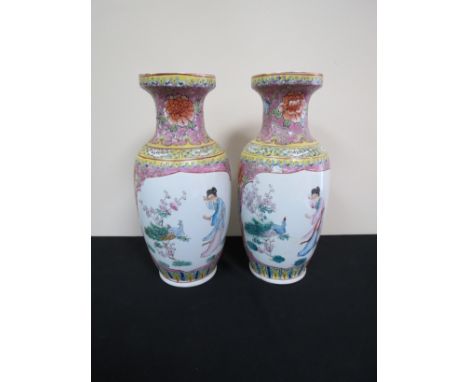 A pair of 20th Century Oriental vases with hand painted enamel detail and figural cartouches, 36.5cm tall