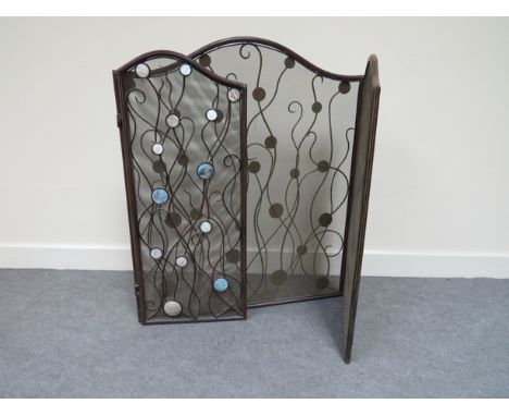 A bronzed metal three fold fire screen with abalone shell roundels 