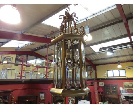 A brassed ceiling lantern with bevelled glass panels 