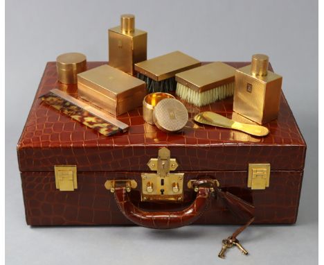 A HERMES CROCODILE LEATHER TRAVELLING CASE, of chocolate brown colour with gilt metal hardware, fitted with two engine-turned