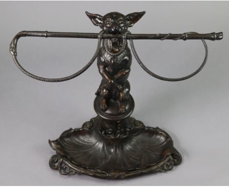 A 19th century COALBROOKDALE NOVELTY CAST IRON STICK STAND in the form of a dog on its hind legs holding a whip in its mouth,