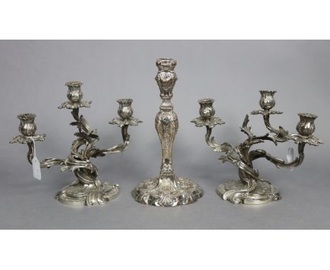 A pair of cast silver-plated dwarf candelabra, each with three foliate scroll arms, on shaped round bases, 9½” high x 11½” wi