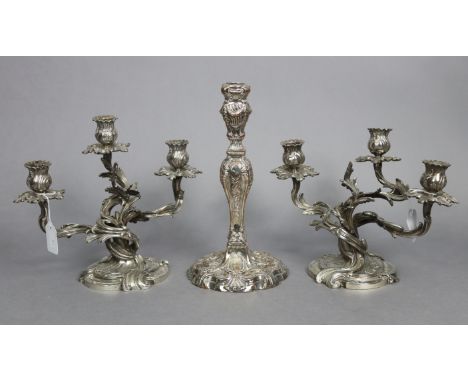 A pair of cast silver-plated dwarf candelabra, each with three foliate scroll arms, on shaped round bases, 9½” high x 11½” wi