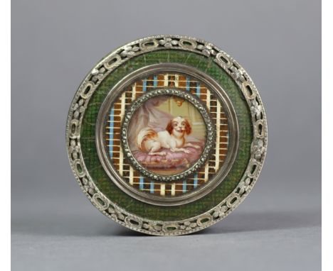 A 19th century French tortoiseshell snuff box, of circular form, inset portrait of a spaniel to the cover, with silvered meta