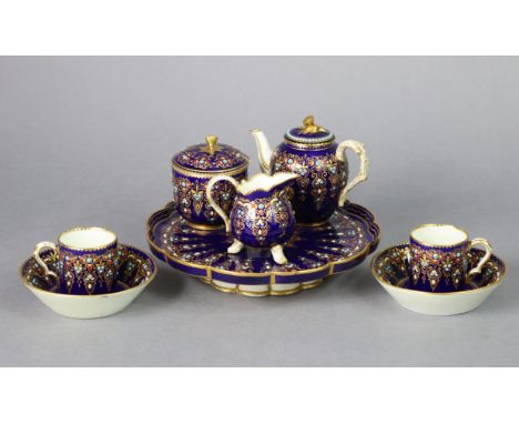 A Sevres-style porcelain cabaret of deep blue ground, with “jewelled” enamel &amp; gilt decoration, comprising: an 8¾” diam. 