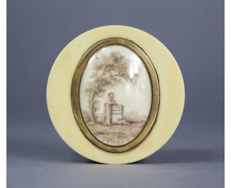 A 19th century ivory snuff box of circular shape, inset oval en-grisaille memento scene in brass mount to the cover; 2.5” dia
