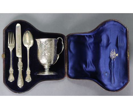 A Victorian silver christening set comprising an engraved mug with rounded base, lobed handle, &amp; on round pedestal foot, 
