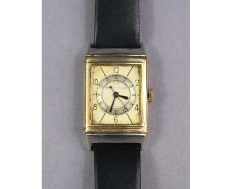 A Jaeger LeCoultre reversible-dial gent’s wristwatch in 9ct. Gold case, the rectangular silvered dial with black Arabic numer