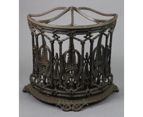 A 19th century COALBROOKDALE CAST IRON DEMI-LUNE STICK STAND, with foliate dividers &amp; pierced fern leaf decoration, on sh