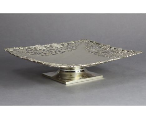A George VI silver large square comport with finely pierced, engraved &amp; cast grapevine border, on short square pedestal f