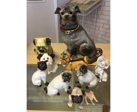 Quantity of pug ceramic dogs to include 19th Century examples.