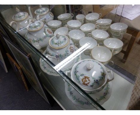 A GUERIN POUYAT ELITE LIMOGES PART TEA SERVICE, THE PIECES WITH THE GILT INITIALS E C WITHIN PURPLE FLOWERING VINES.