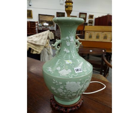 A CHINESE CELADON GROUND TWO HANDLED BOTTLE VASE AS A LAMP, THE BODY DECORATED IN WHITE WITH BATS, FLOWERS AND RIBBON TIED PR