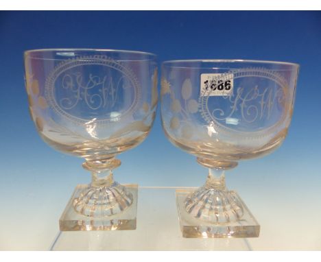 A PAIR OF RUMMERS, THE BOWLS ENGRAVED WITH OVALS CONTAINING THE INITIALS Y C W FLANKED BY THISTLES AND ROSES ABOVE SQUARE LEM
