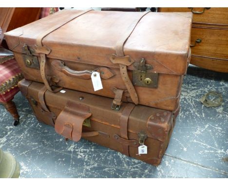 A LARGE VINTAGE LEATHER SUITCASE AND A SIMILAR LEATHER MOUNTED CANVAS EXAMPLE.  (2)