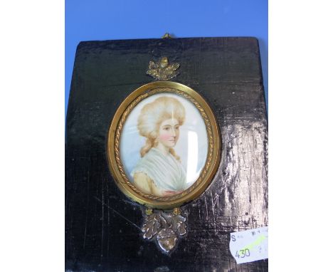A 19th.C. PORTRAIT MINIATURE A MAN WEARING A MAUVE COAT TOGETHER WITH TWO DECORATIVE MINIATURES OF 18th.C. LADIES, VARIOUSLY 