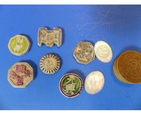 SIX CHINESE PORCELAIN GAMBLING TOKENS TOGETHER WITH MOTHER OF PEARL COUNTERS INITIALLED C, SOME WITHIN AN IVORY BOX.   Dia. 3