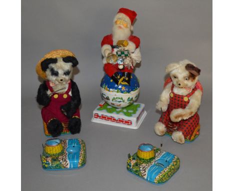 Three unboxed vintage Japanese battery operated tinplate toys including a Noel Decorations Inc. revolving 'Animated Santa' fi