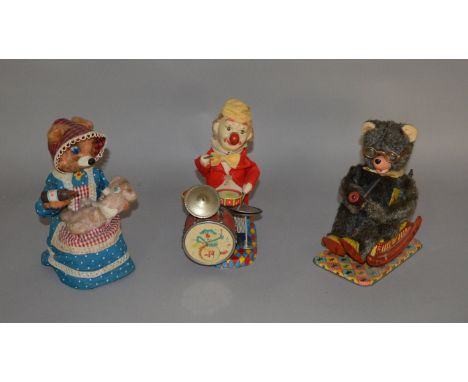 Three unboxed vintage Japanese battery operated tinplate toys including a Yonezawa (Japan)  Mother Bear figure, seated on a t