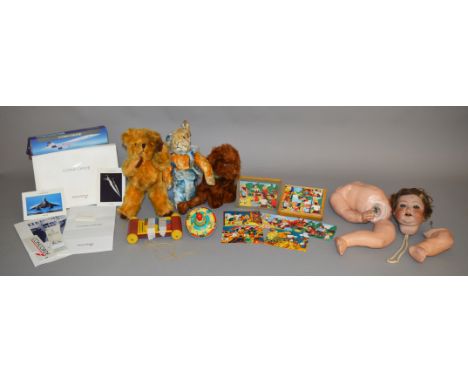 A mixed selection of vintage toys, mostly unboxed, including a Chiltern rabbit and two other  soft toys, a porcelain doll wit