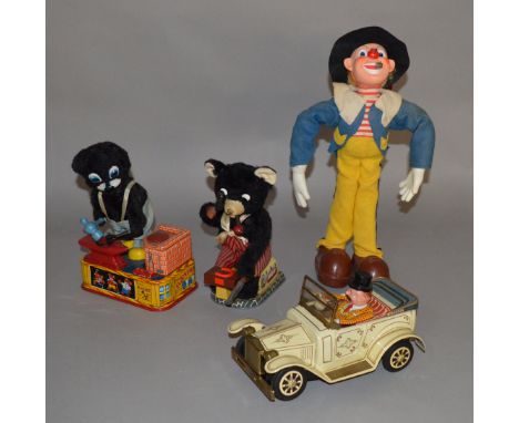 Three unboxed vintage Japanese battery operated tinplate toys including an  A1 Toys 'Blacksmith Bear', a similar 'Smithy' bea