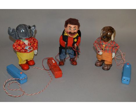 Three unboxed vintage Japanese battery operated tinplate toys including a 'walking' Dog figure with pipe, manufactured by Mar