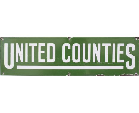Motoring Bus enamel poster board heading UNITED COUNTIES. Measures 20in x 5.5in and is in good condition with some chipping.