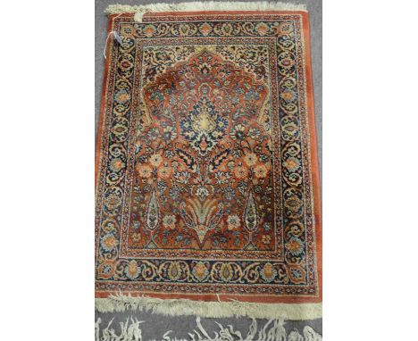 A small 20th Century Middle Eastern Schirwan orange ground prayer mat/rug decorated with floral design, 90 x 62cm