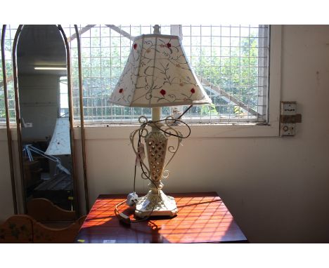 A decorated wooden and metal table lamp with floral shade  