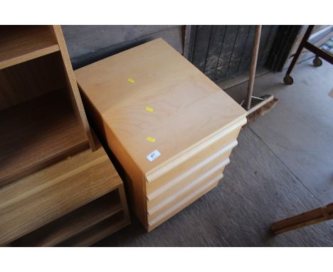 A light wood four drawer bedside chest