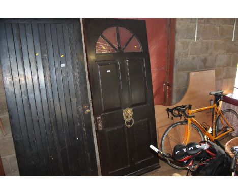 A hardwood front door with lion mask door knocker