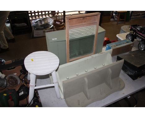 A green painted wall cupboard; two hanging coat racks and a washboard
