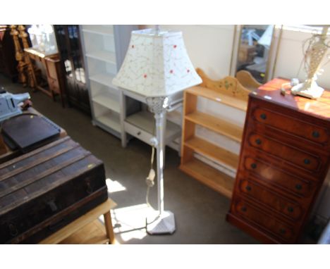 A painted standard lamp with floral shade 