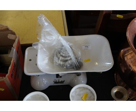 A set of enamel kitchen scales and weights 
