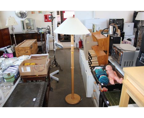 A modern light wood standard lamp and shade