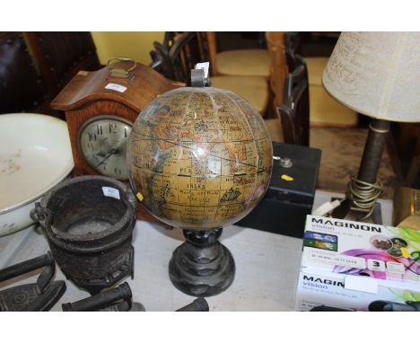 A vintage globe on wooden and metal stand 