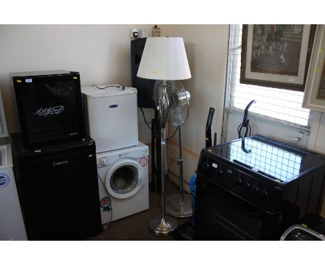 A modern metal standard lamp and shade