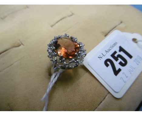 A 9ct white gold dress ring set with orange gem stone size O