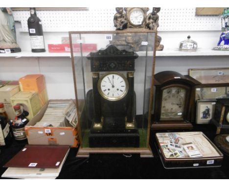 A 19th century French mantle clock in glass case
