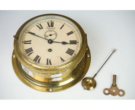 Brass Cased Circular Ships Bulk Head style Clock, the dial with Roman numerals, seconds dial and fast / slow switch, 20cm dia