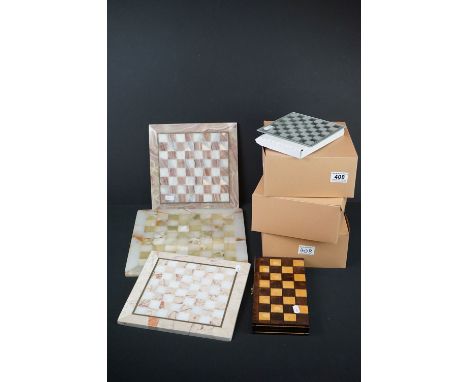 A collection of chess sets to include stone and wooden examples together with boards. 