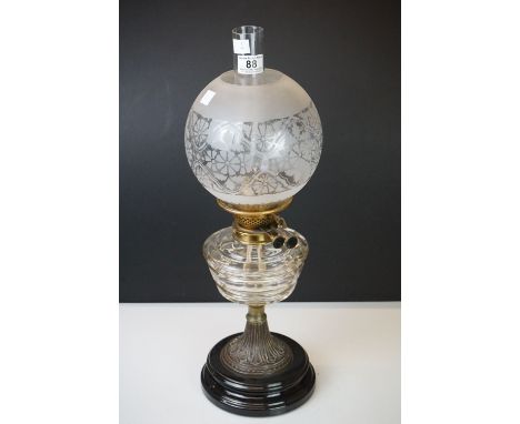 Late 19th / Early 20th century oil lamp with clear cut glass layered pattern font, brass base with black china foot, Messenge